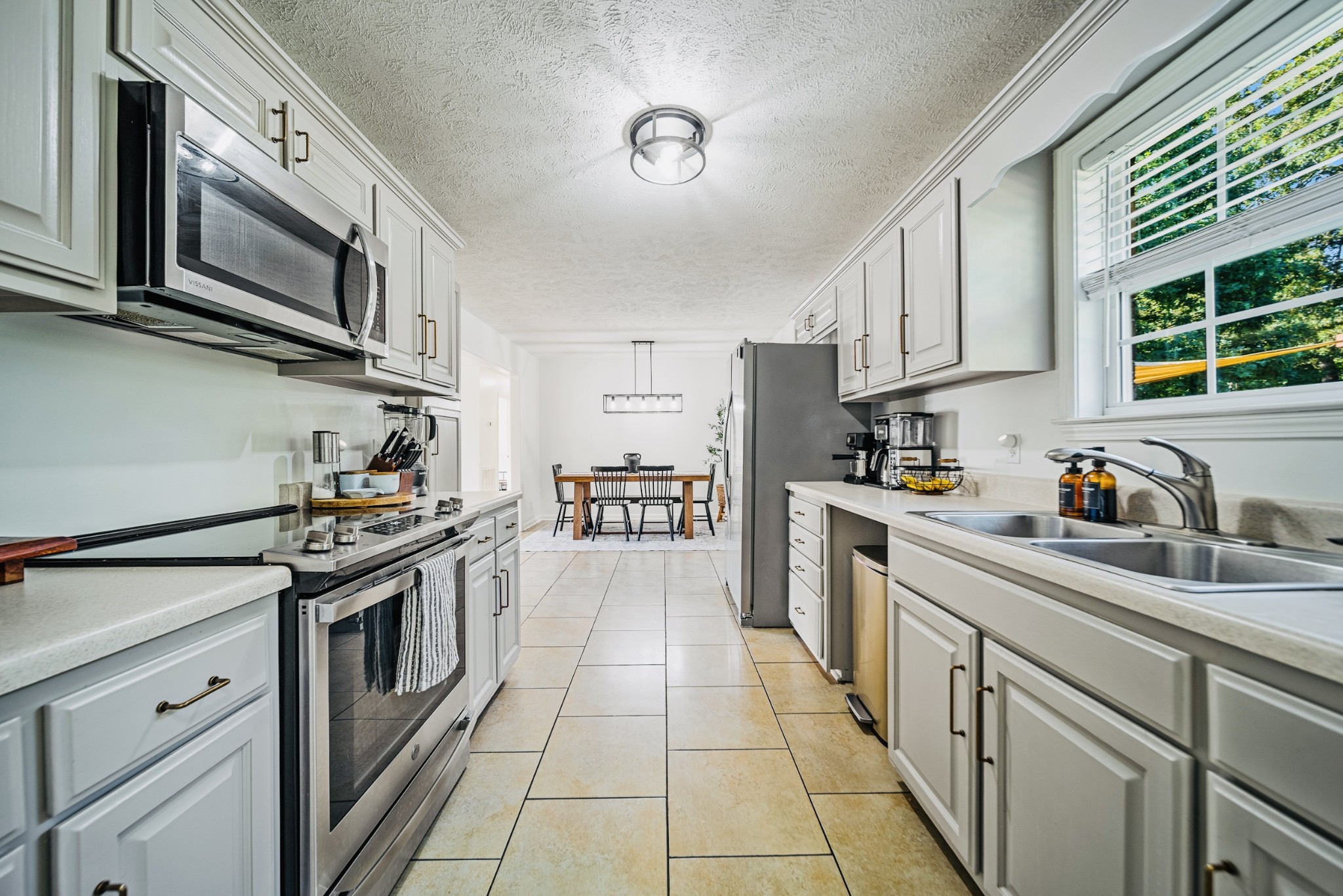 335 Oak Hollow Road Manchester, TN 37355 - Photo 8 of 21 a kitchen with stainless steel appliances granite countertop a stove top oven a sink dishwasher and white cabinets with wooden floor