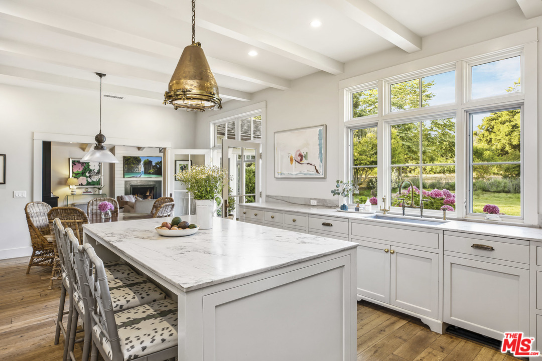 4646 Via Roblada Santa Barbara, CA 93110 - Photo 11 of 36 a kitchen with kitchen island granite countertop a sink and center island