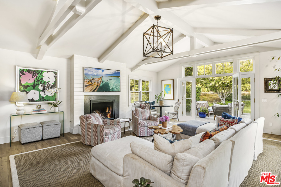 4646 Via Roblada Santa Barbara, CA 93110 - Photo 19 of 36 a living room with furniture a fireplace and a large window