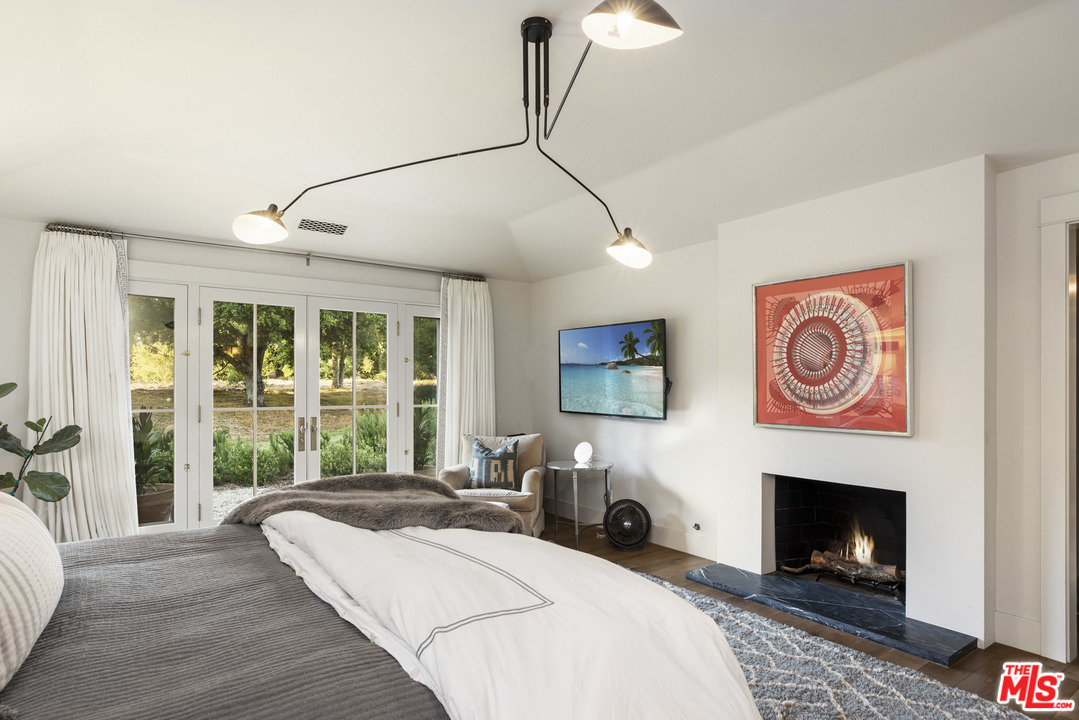 4646 Via Roblada Santa Barbara, CA 93110 - Photo 23 of 36 a living room with furniture and a fireplace