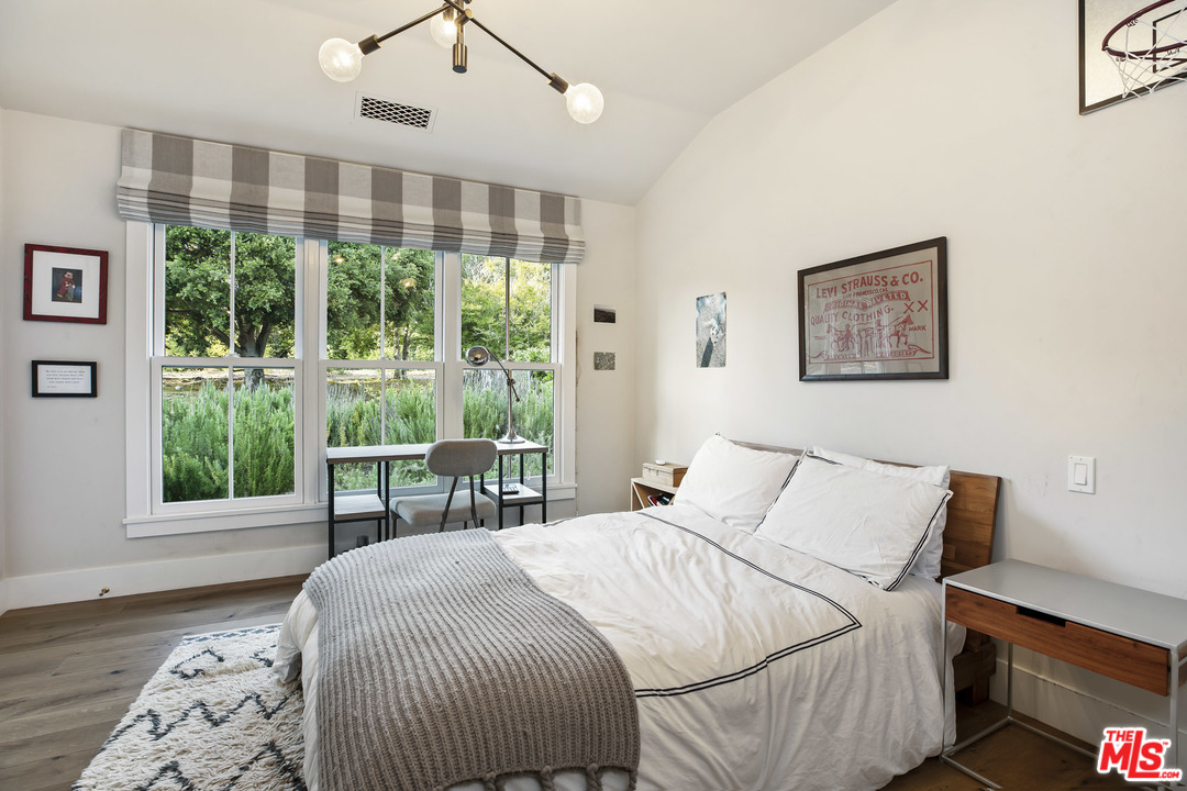 4646 Via Roblada Santa Barbara, CA 93110 - Photo 28 of 36 a bedroom with a large bed and a large window