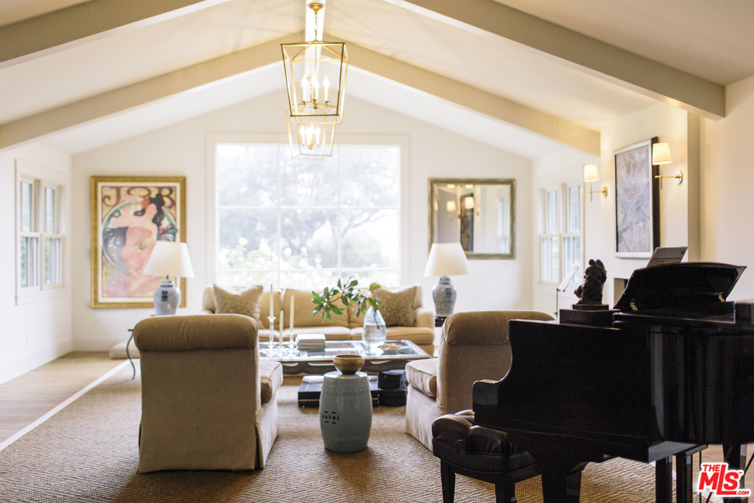 4646 Via Roblada Santa Barbara, CA 93110 - Photo 7 of 36 a living room with furniture windows and a chandelier