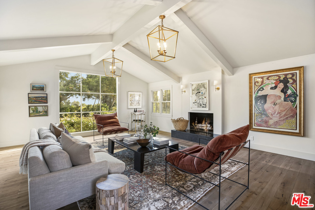 4646 Via Roblada Santa Barbara, CA 93110 - Photo 8 of 36 a living room with furniture a fireplace and a chandelier