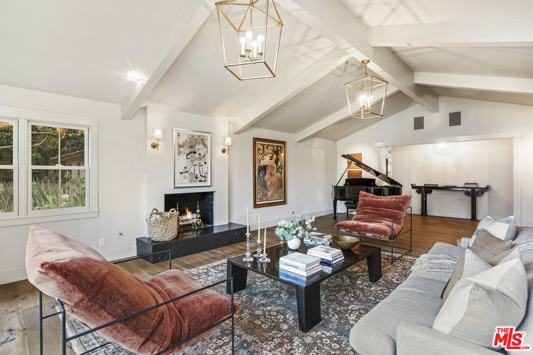 4646 Via Roblada Santa Barbara, CA 93110 - Photo 9 of 36 a living room with furniture a fireplace and a window