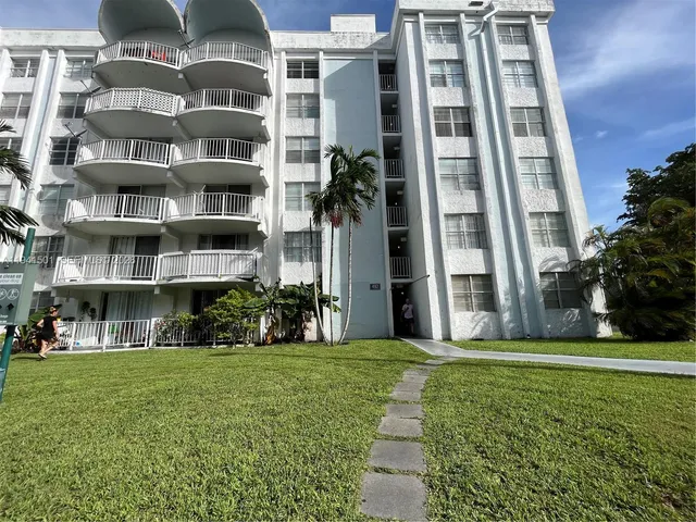 a view of a building with a yard