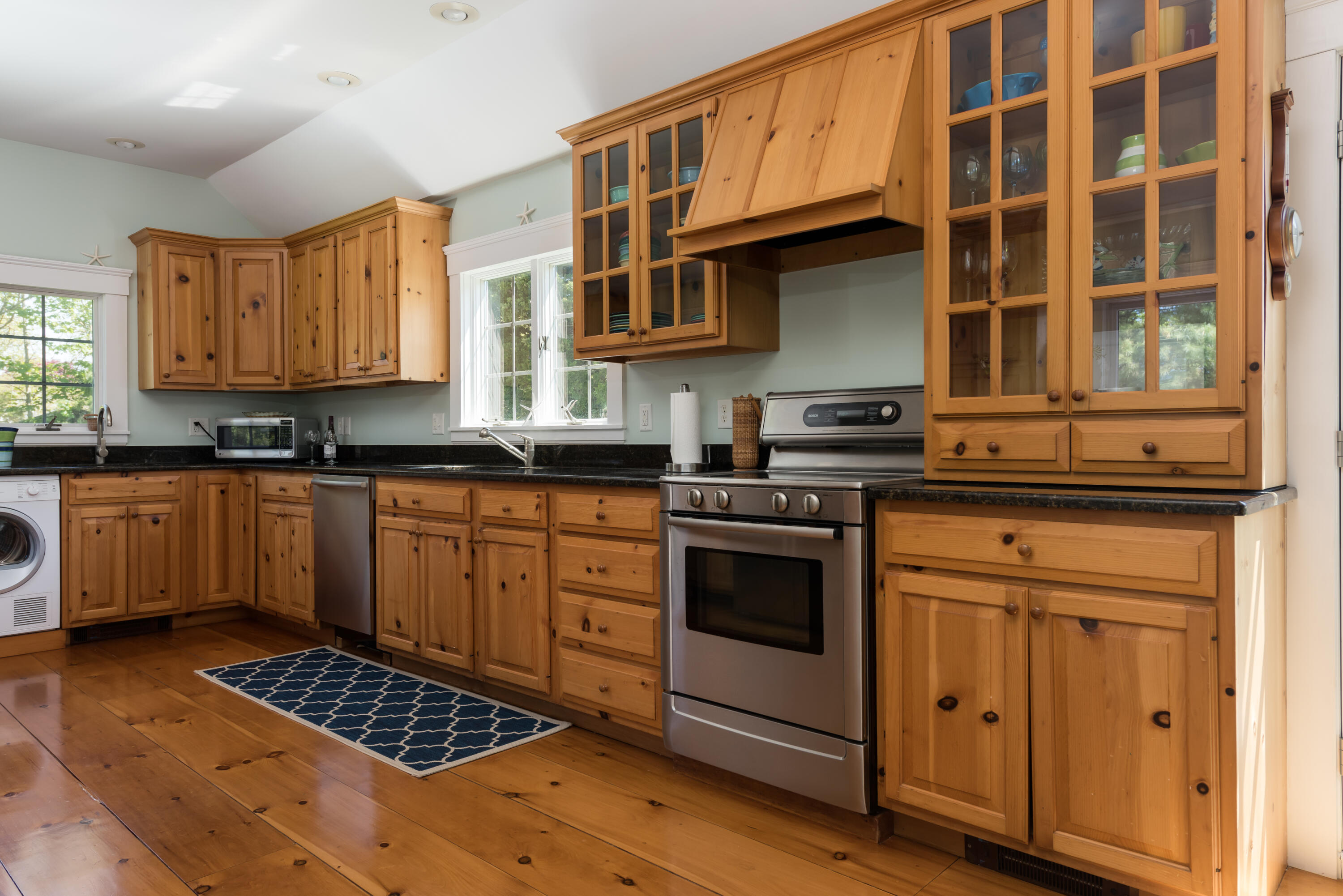 8 Gorham Road Harwich, MA 02645 - Photo 9 of 33 a kitchen with stainless steel appliances granite countertop a stove and cabinets