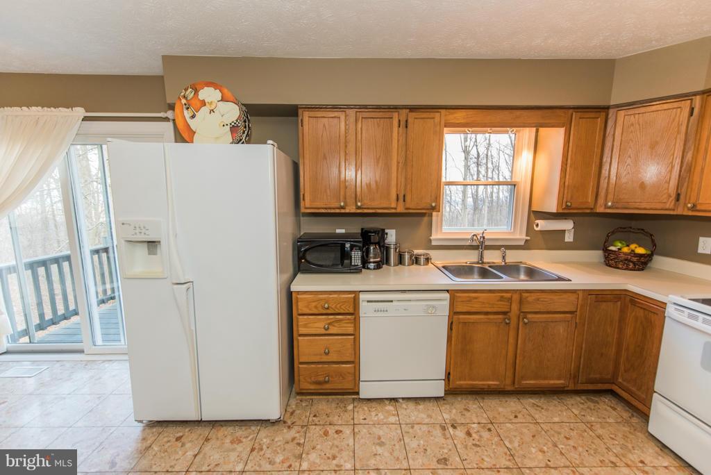 3 Blue Sky Road Linden, VA 22642 - Photo 14 of 30 a kitchen with a refrigerator and a sink
