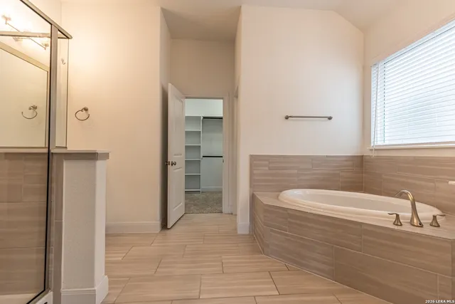 a bathroom with a bathtub and a sink
