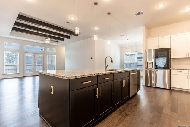 a view of kitchen and hall with wooden floor