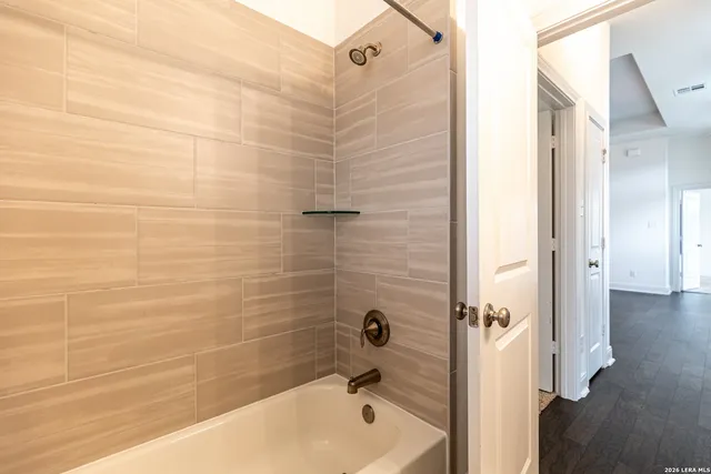 a bathroom with a bathtub and shower