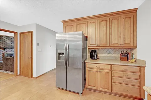 a kitchen with stainless steel appliances granite countertop a refrigerator and cabinets