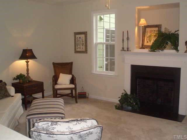 4415 Log Cabin Drive Raleigh, NC 27616 - Photo 3 of 10 Lovely living room with slate-surround fireplace, detailed mantel, and gas logs. Note the wooden casements around the windows! Hanging blinds is a cinch! Other
