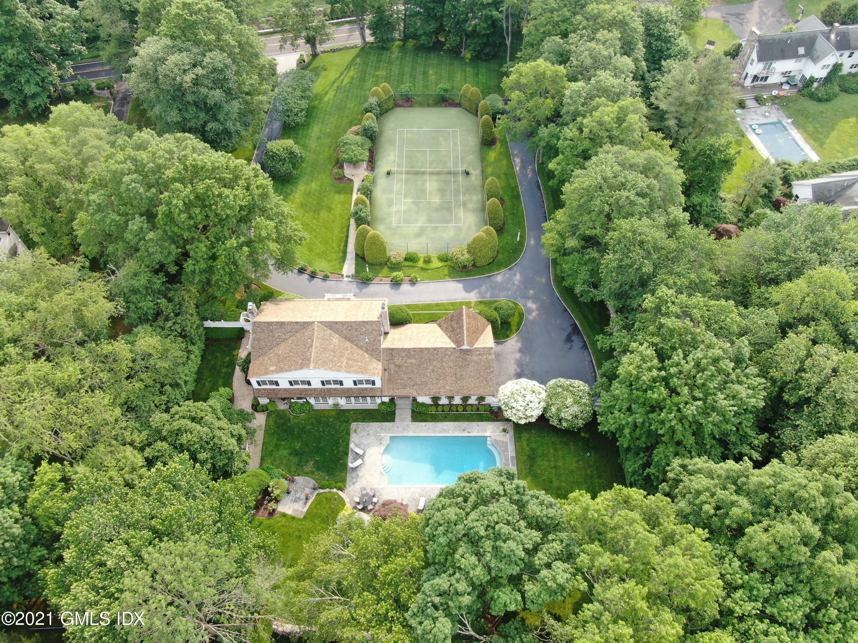 an aerial view of a house with a yard and lake view