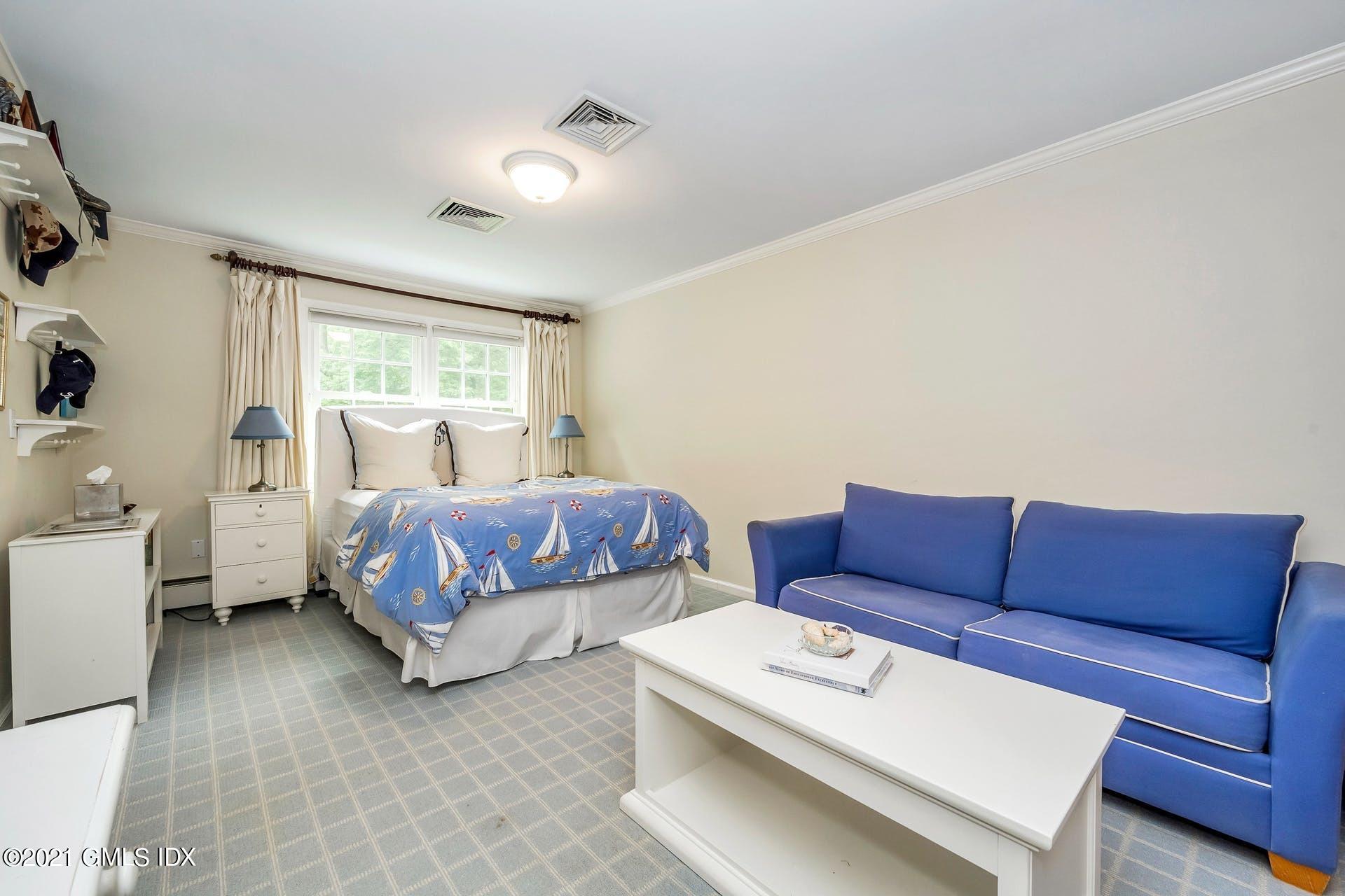 425 Stanwich Road Greenwich, CT 06830 - Photo 16 of 36 a bedroom with a bed and a couch