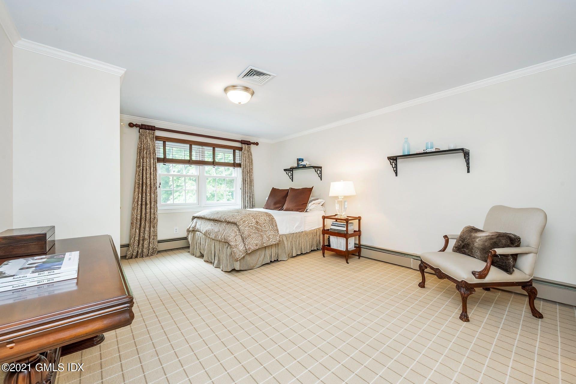 425 Stanwich Road Greenwich, CT 06830 - Photo 18 of 36 a bedroom with a bed and a window