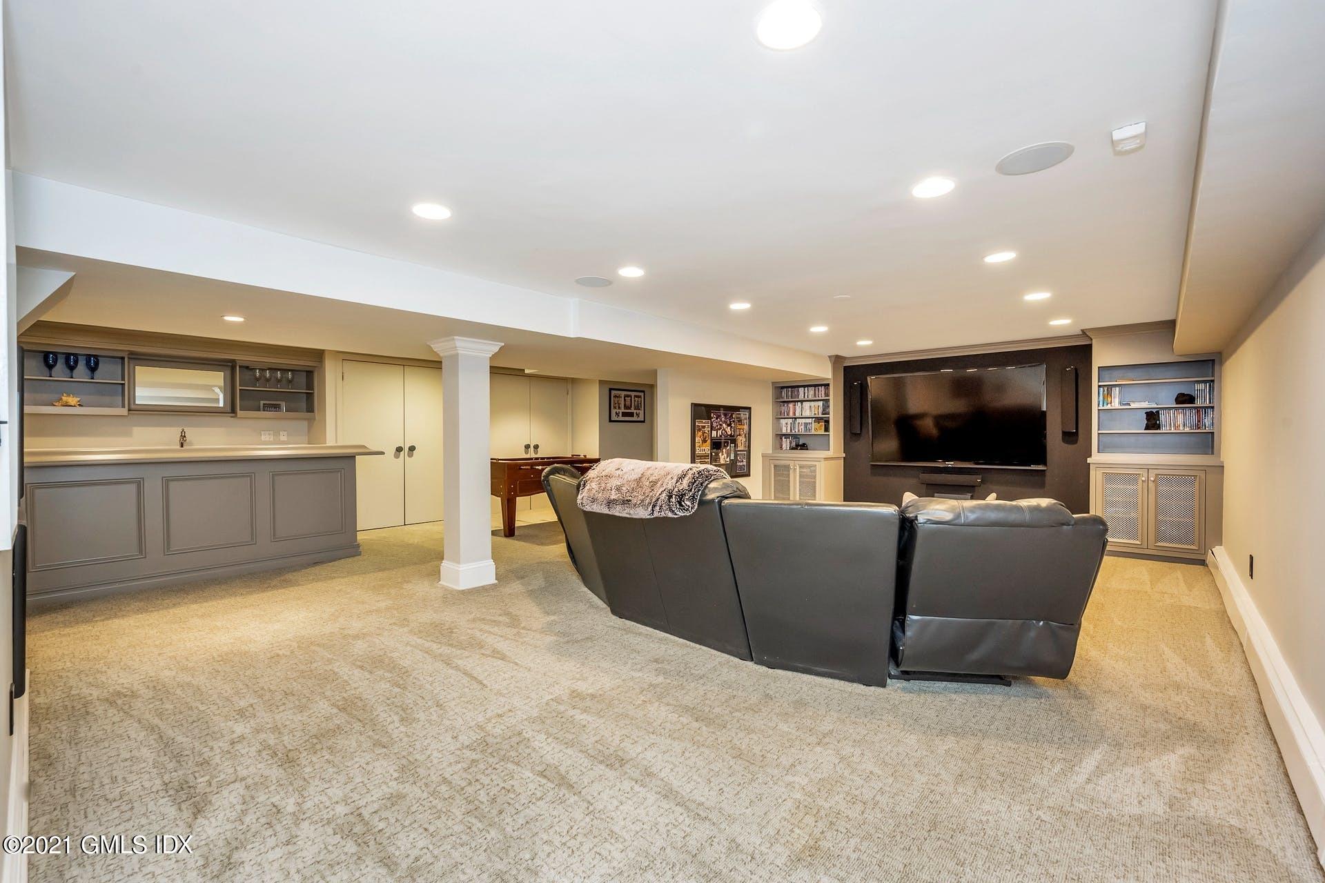 425 Stanwich Road Greenwich, CT 06830 - Photo 22 of 36 a living room with furniture and a flat screen tv