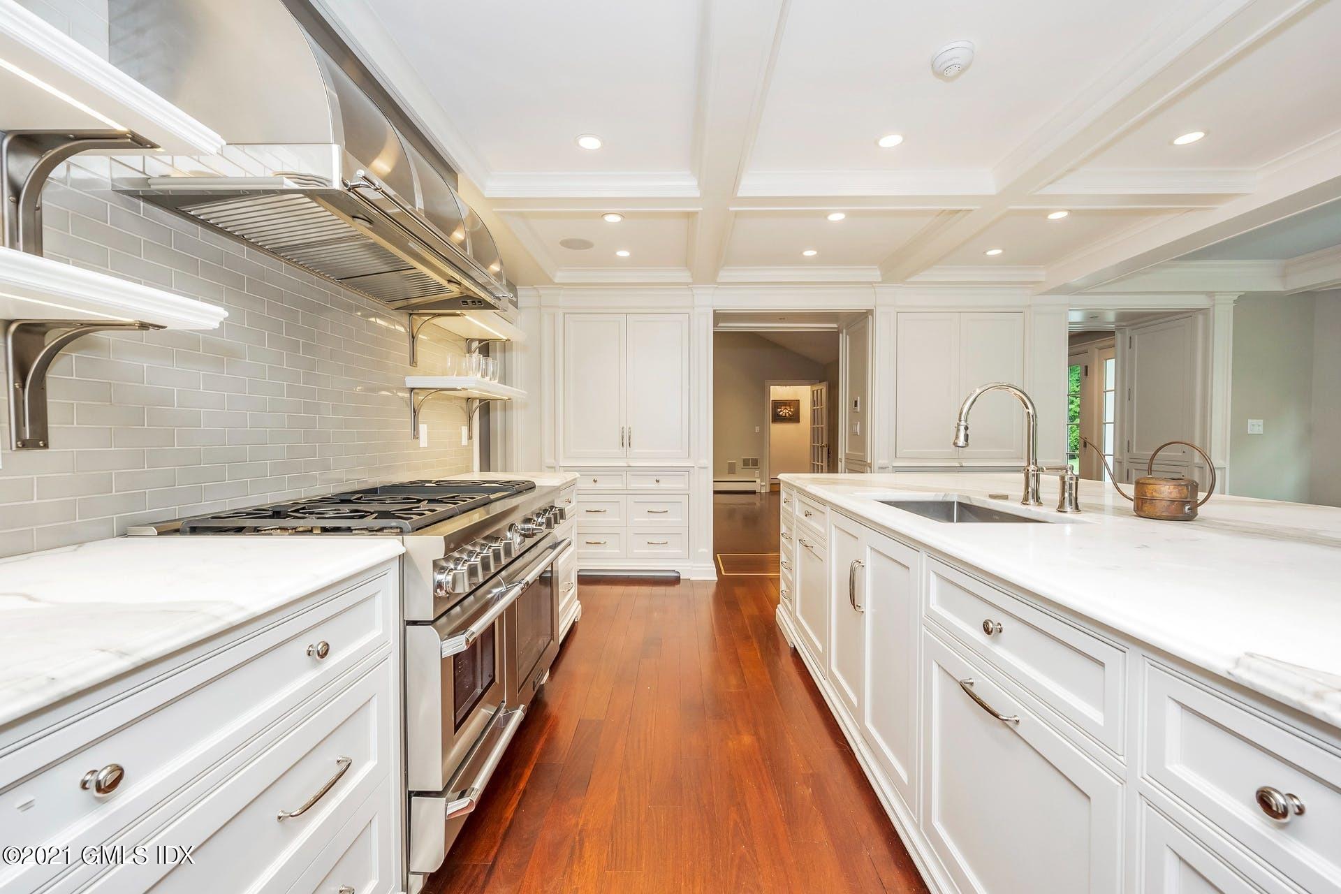 425 Stanwich Road Greenwich, CT 06830 - Photo 6 of 36 a large kitchen with a large counter top a stove and a sink