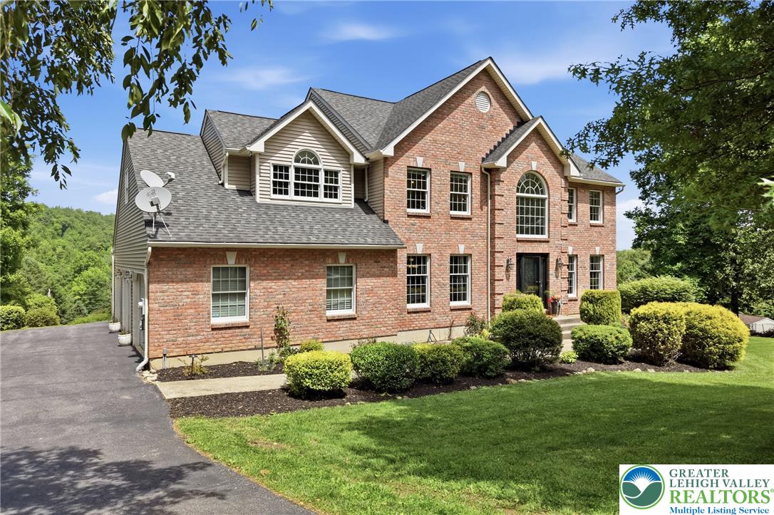 115 West Butternut Road Hellertown, PA 18055 - Photo 96 of 97 A classic brick exterior with well-maintained landscaping and a winding asphalt driveway welcomes you home.