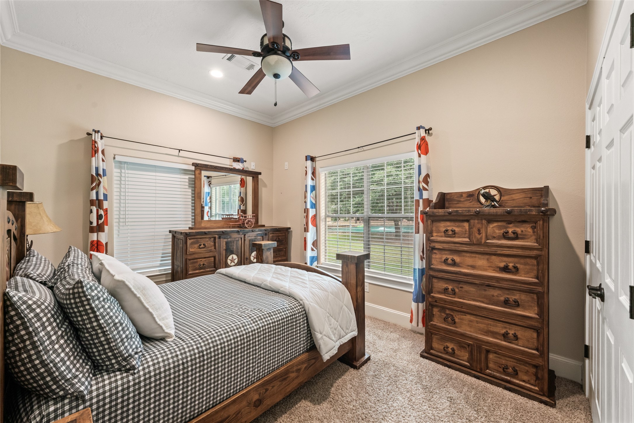 32660 Willow Bend Road Waller, TX 77484 - Photo 21 of 47 Comfortable bedroom featuring a tray ceiling, ceiling fan, neutral finishes, and a large window providing natural light.