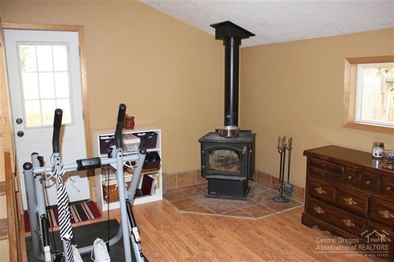 20284 Murphy Road Bend, OR 97702 - Photo 11 of 22 The bonus room's fireplace. A door prov