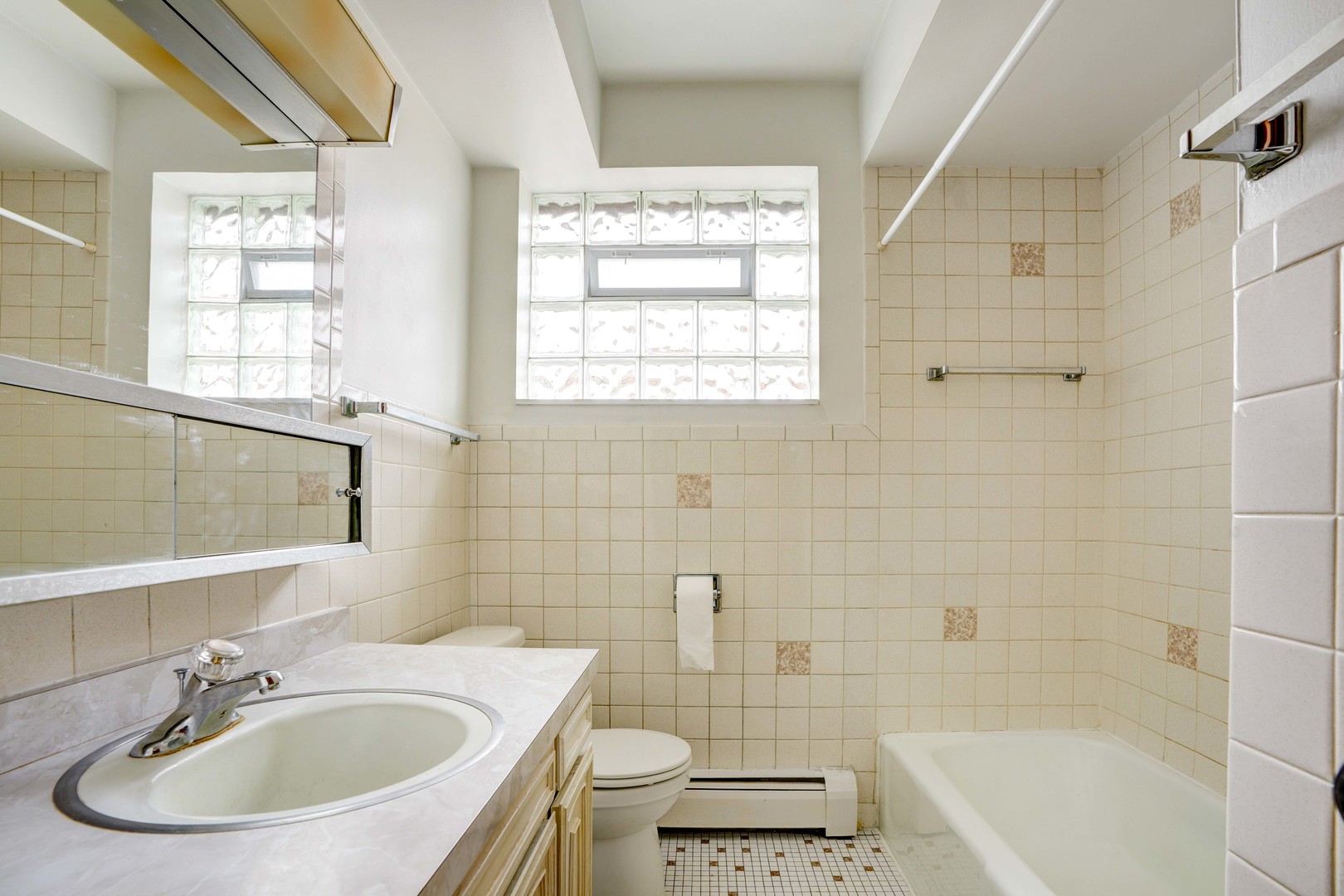 8444 West Gregory Street, Unit 3B Chicago, IL 60656 - Photo 8 of 9 a bathroom with a sink toilet a mirror and bathtub