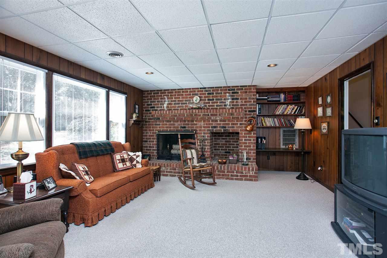 730 Hardimont Road Raleigh, NC 27609 - Photo 12 of 19 a living room with furniture a fireplace and a floor to ceiling window