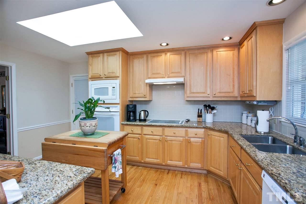 730 Hardimont Road Raleigh, NC 27609 - Photo 6 of 19 a kitchen with stainless steel appliances granite countertop a sink a stove and a wooden floors