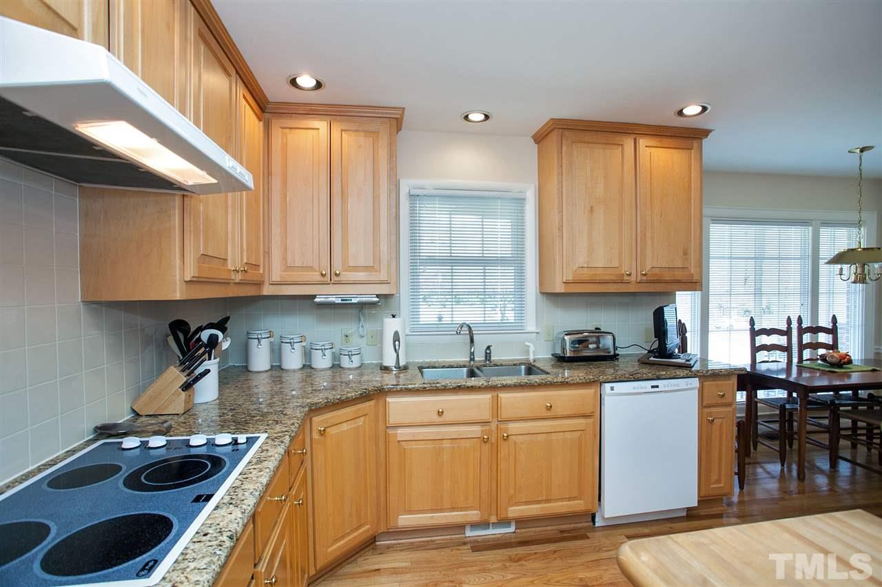 730 Hardimont Road Raleigh, NC 27609 - Photo 7 of 19 a kitchen with stainless steel appliances granite countertop a stove a sink a refrigerator and cabinets