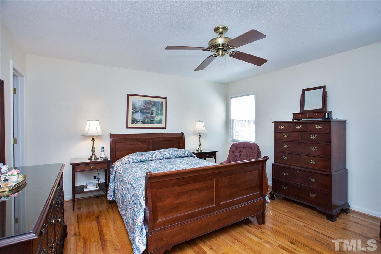 730 Hardimont Road Raleigh, NC 27609 - Photo 9 of 19 a bedroom with a bed and wooden floor