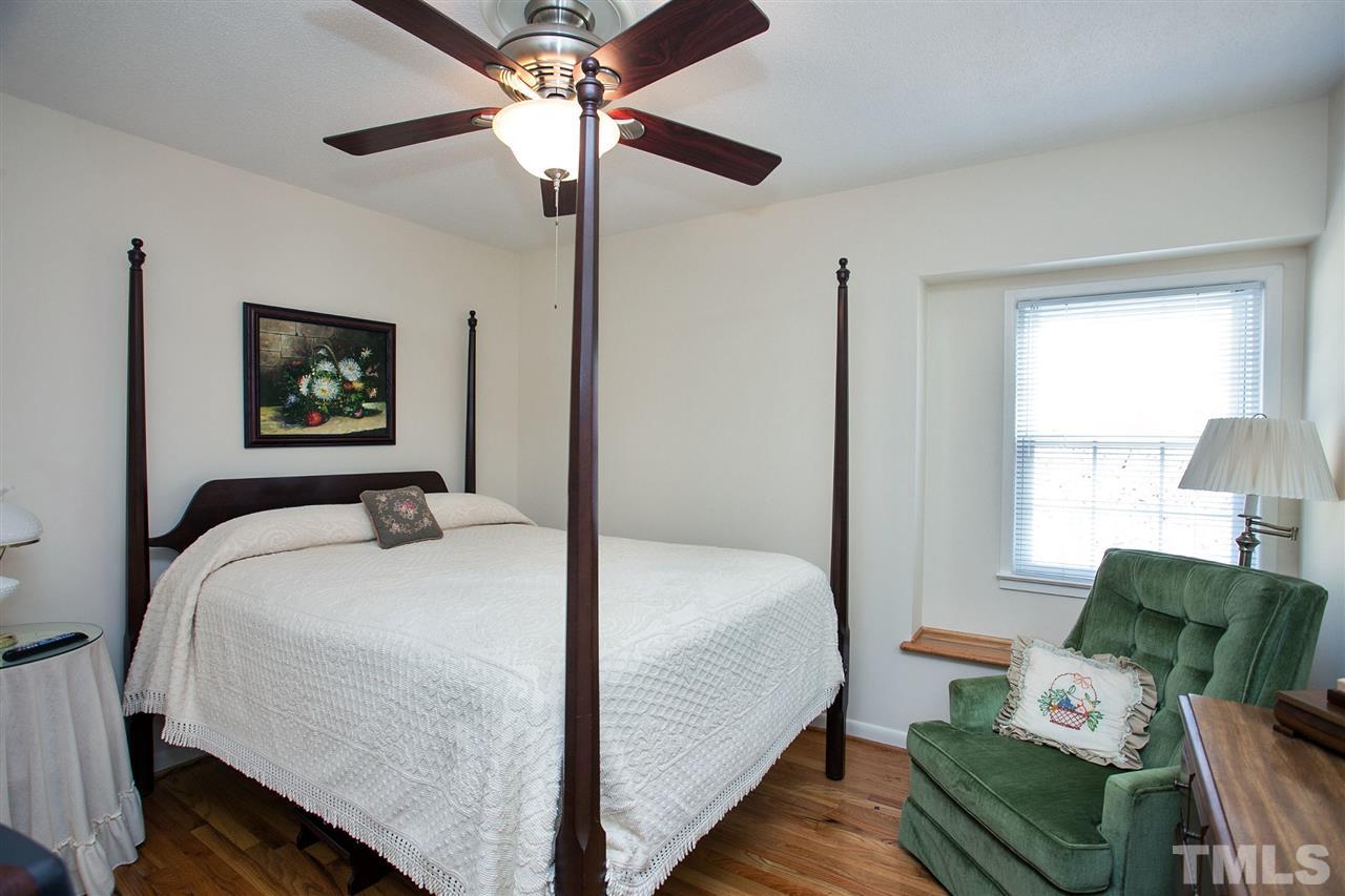 730 Hardimont Road Raleigh, NC 27609 - Photo 10 of 19 a bedroom with a bed and wooden floor