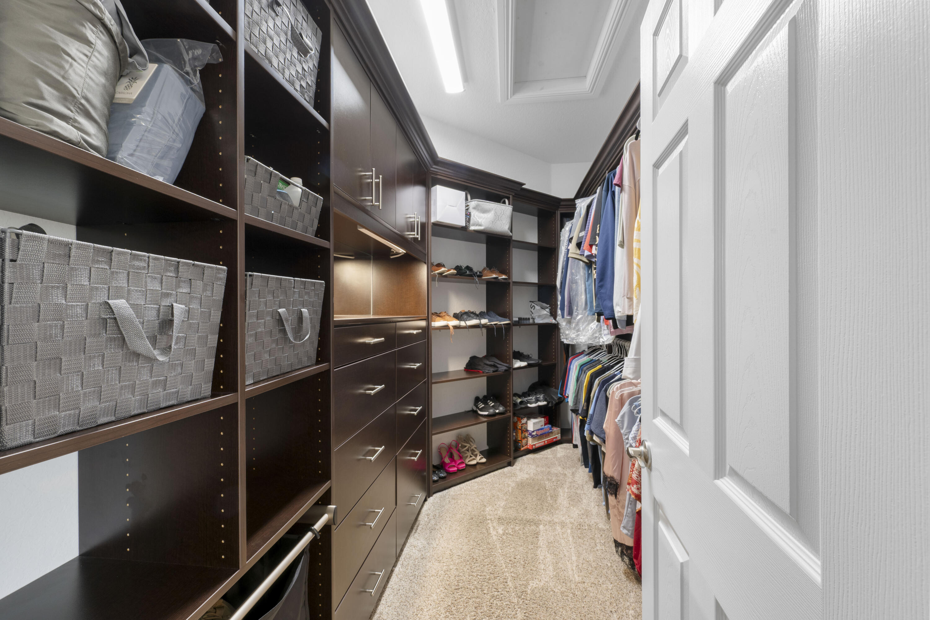 Undisclosed Address Stuart, FL 34997 - Photo 11 of 13 a view of walk in closet with clothes and shoes