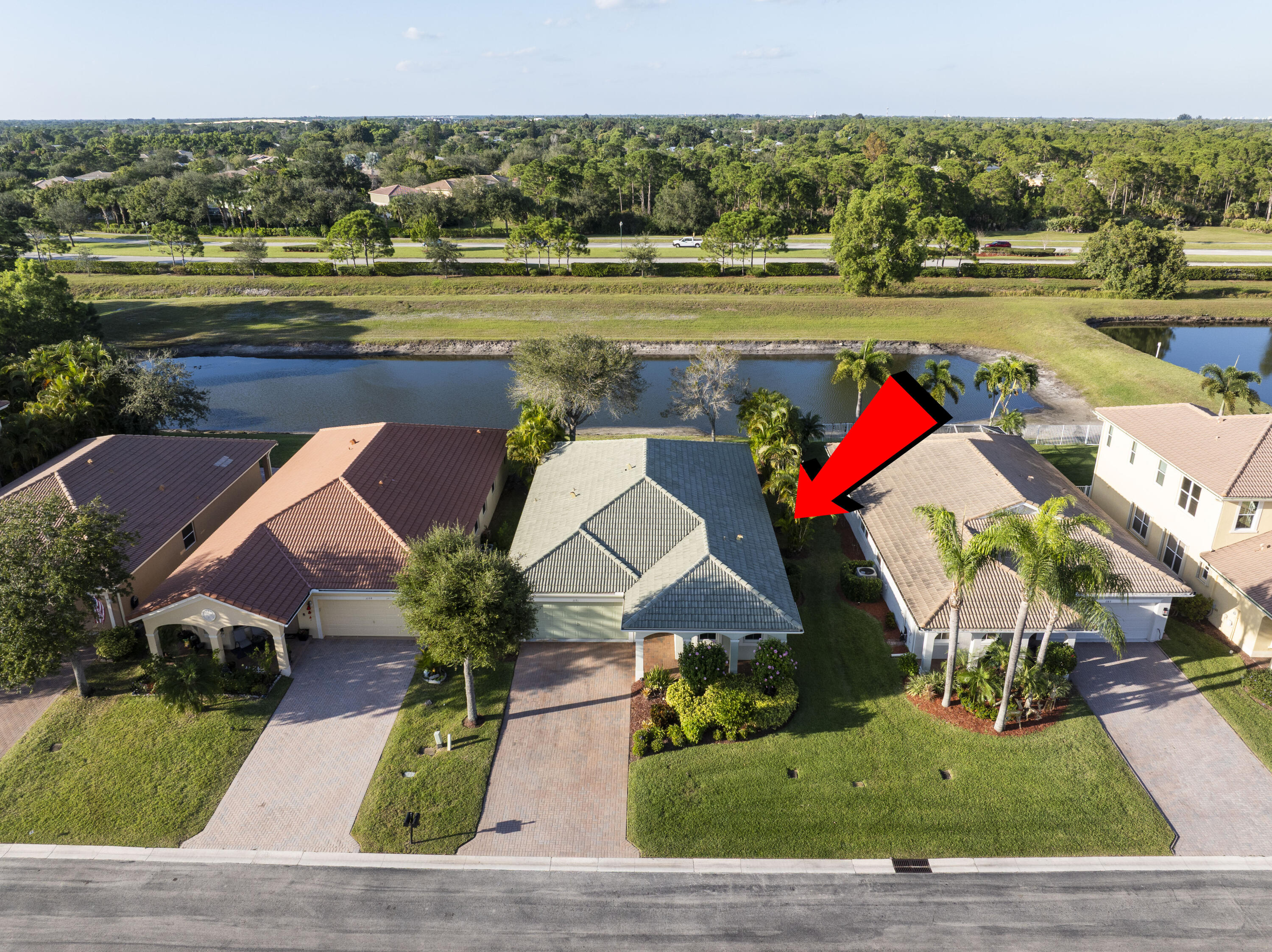 Undisclosed Address Stuart, FL 34997 - Photo 3 of 13 an aerial view of a house with a yard and lake view