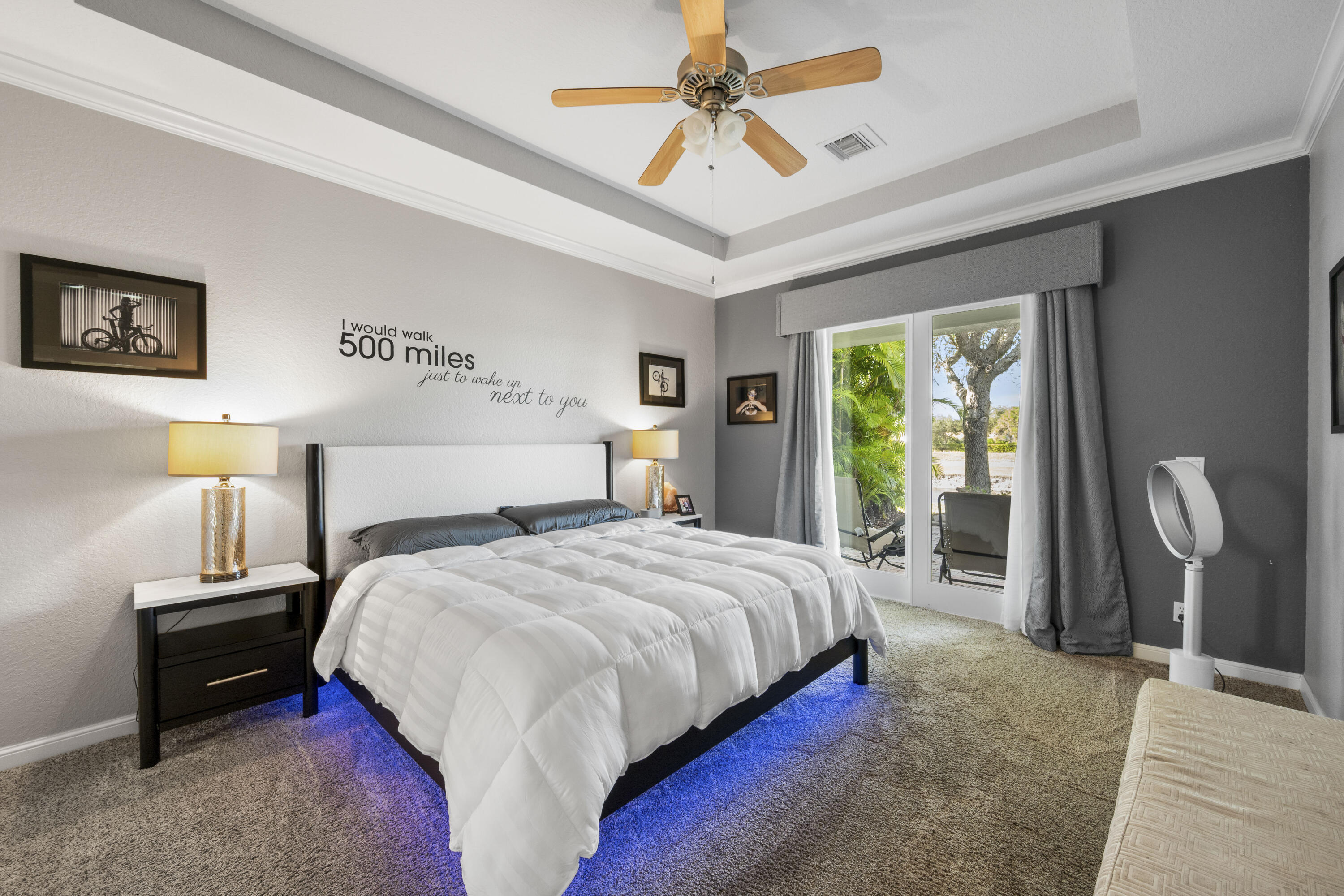 Undisclosed Address Stuart, FL 34997 - Photo 9 of 13 a bedroom with a bed desk and a window