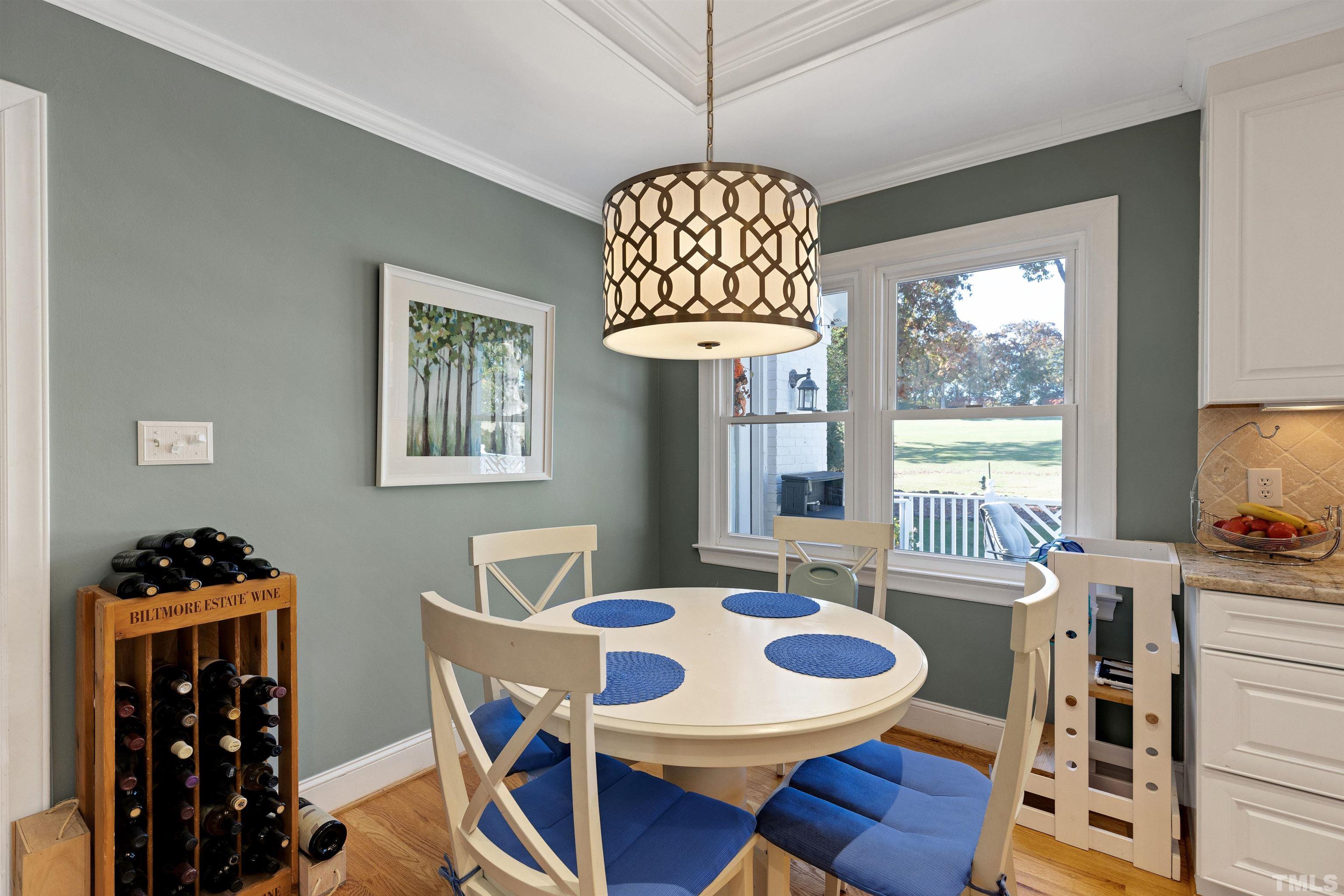 6813 Foxfire Place Raleigh, NC 27615 - Photo 12 of 34 a view of a dining room with furniture a chandelier and wooden floor