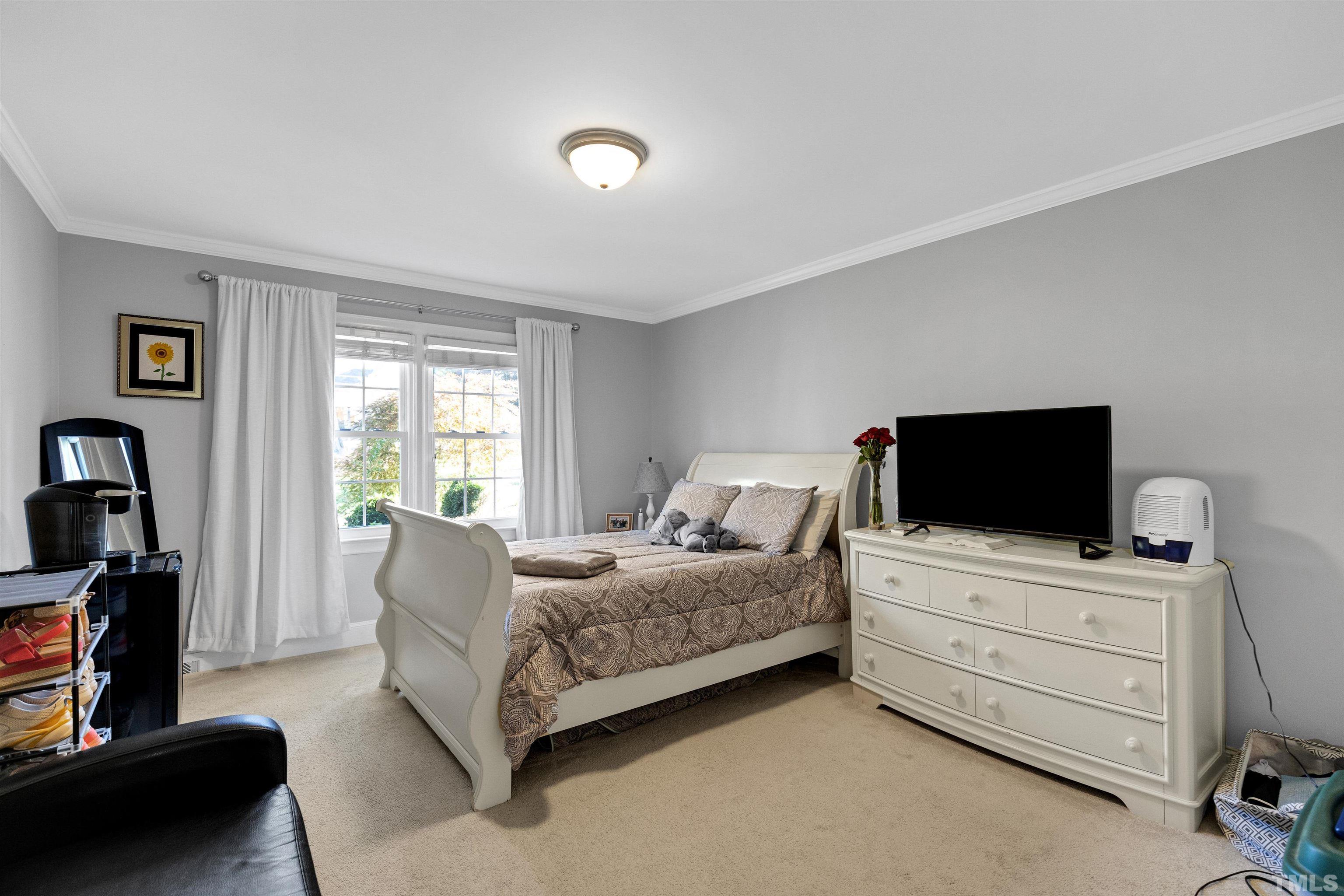 6813 Foxfire Place Raleigh, NC 27615 - Photo 16 of 34 a living room with furniture and a flat screen tv