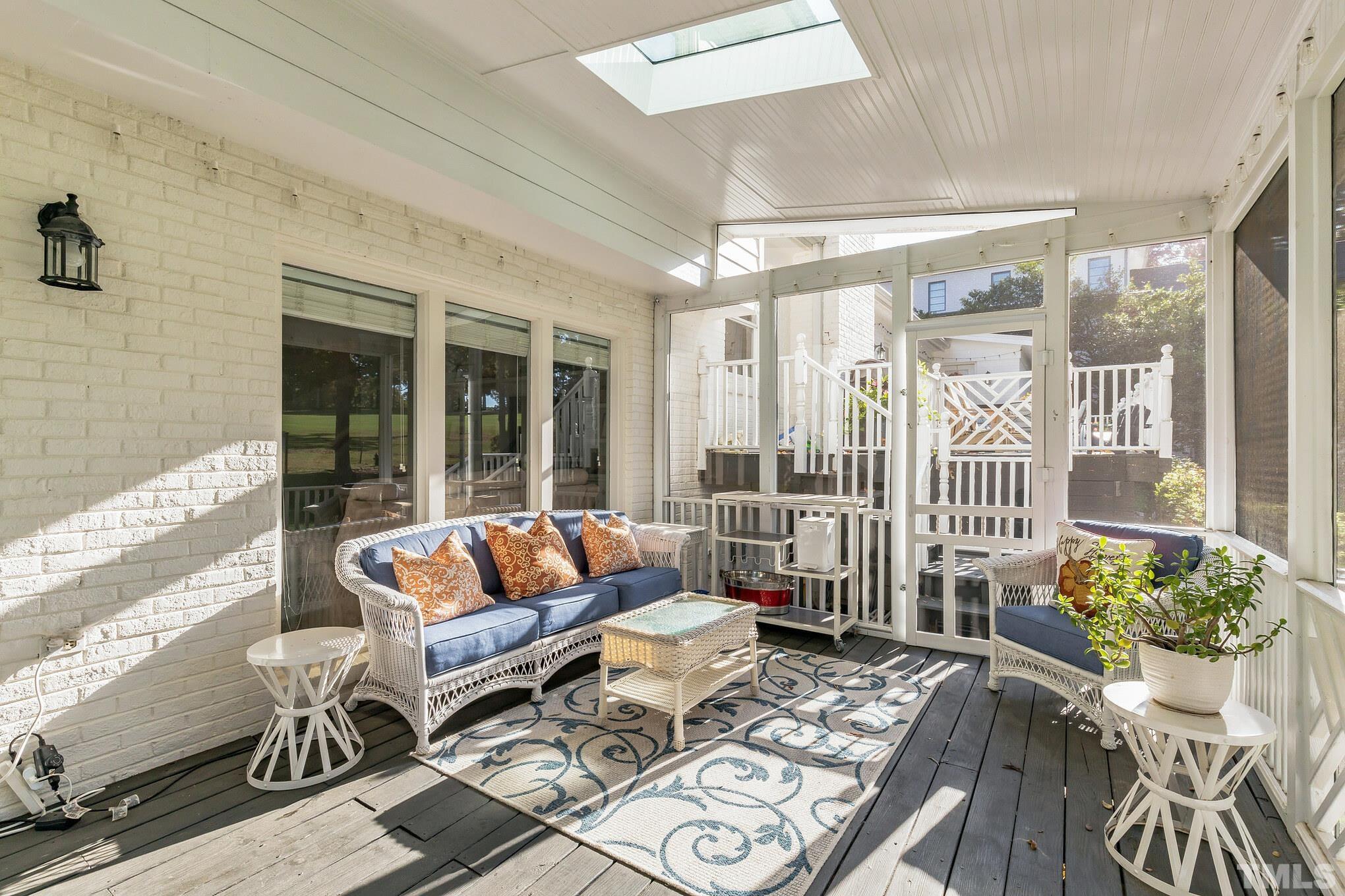 6813 Foxfire Place Raleigh, NC 27615 - Photo 26 of 34 a living room with furniture and a large window with garden view