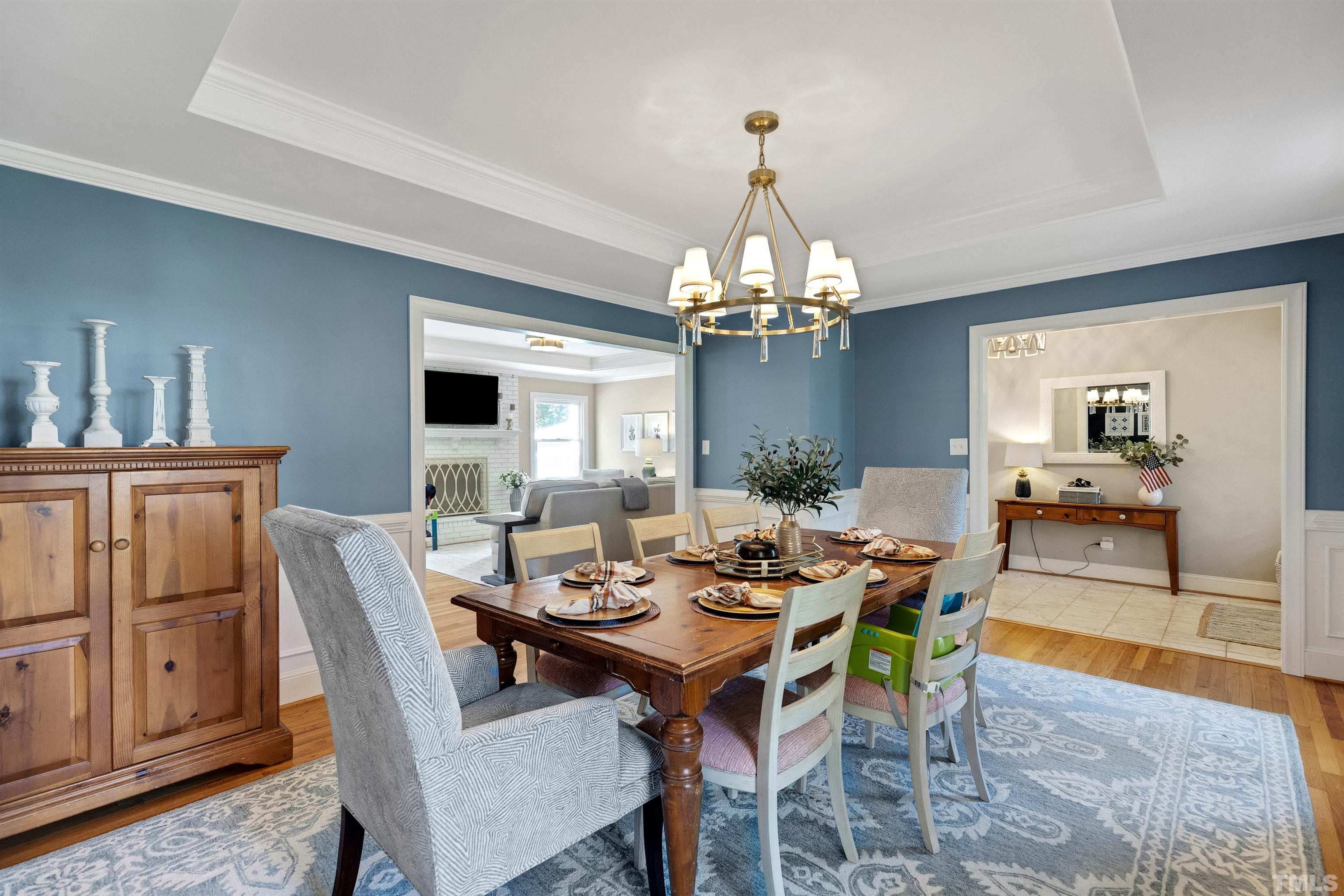 6813 Foxfire Place Raleigh, NC 27615 - Photo 6 of 34 a view of a dining room with furniture and chandelier