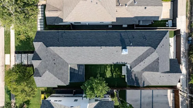 an aerial view of a house with a yard