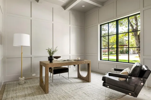 a living room with furniture a window and a potted plant