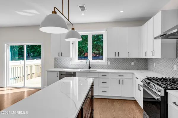 a kitchen with a stove a sink and a refrigerator