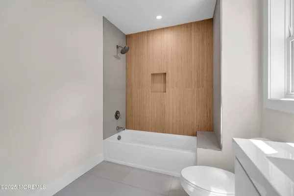 a bathroom with a bathtub a toilet and a shower