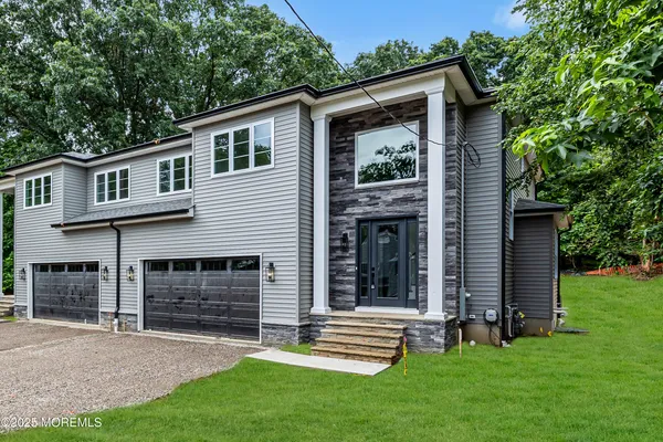 a front view of a house with a yard