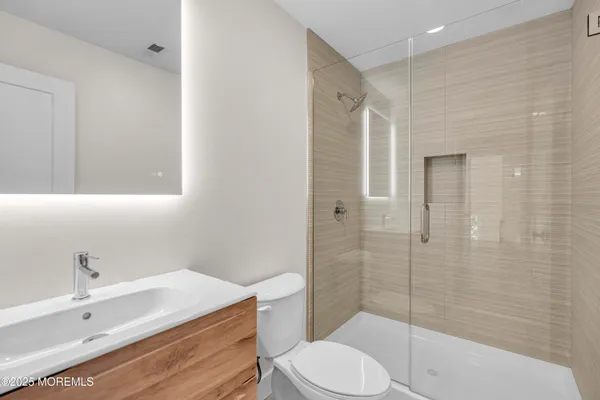 a bathroom with a sink toilet and shower