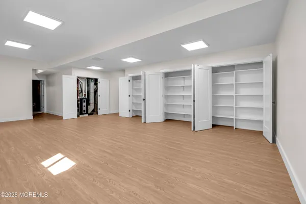 an empty room with a closet and storage