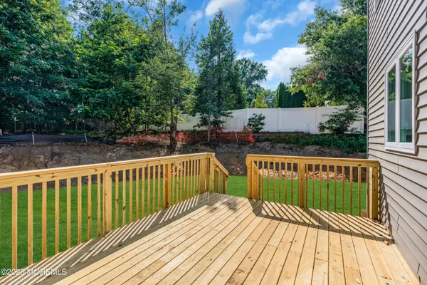 a view of balcony with wooden floor and fence