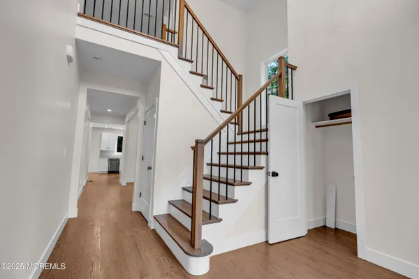 a view of entryway and hall with wooden floor