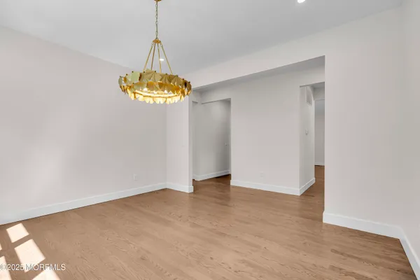 a view of a chandelier in big room and a chandelier fan