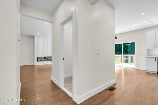 a view of a hallway with wooden floor