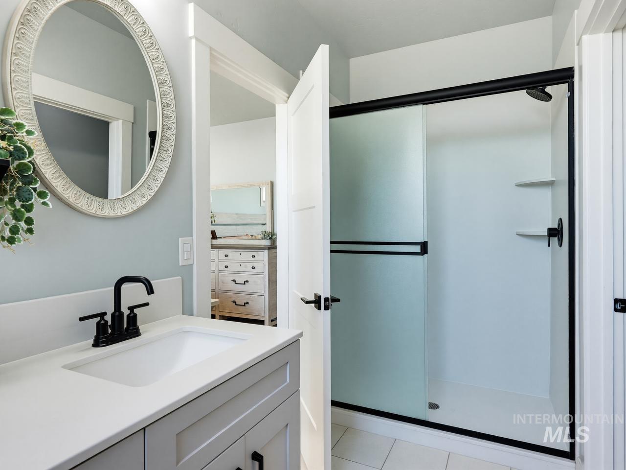 4950 West Columbia Road Nampa, ID 83687 - Photo 26 of 50 Bathroom featuring a single vanity with a white countertop, undermount sink, and matte black faucet