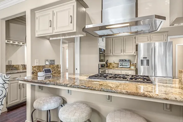 a kitchen with stainless steel appliances granite countertop a sink and cabinets